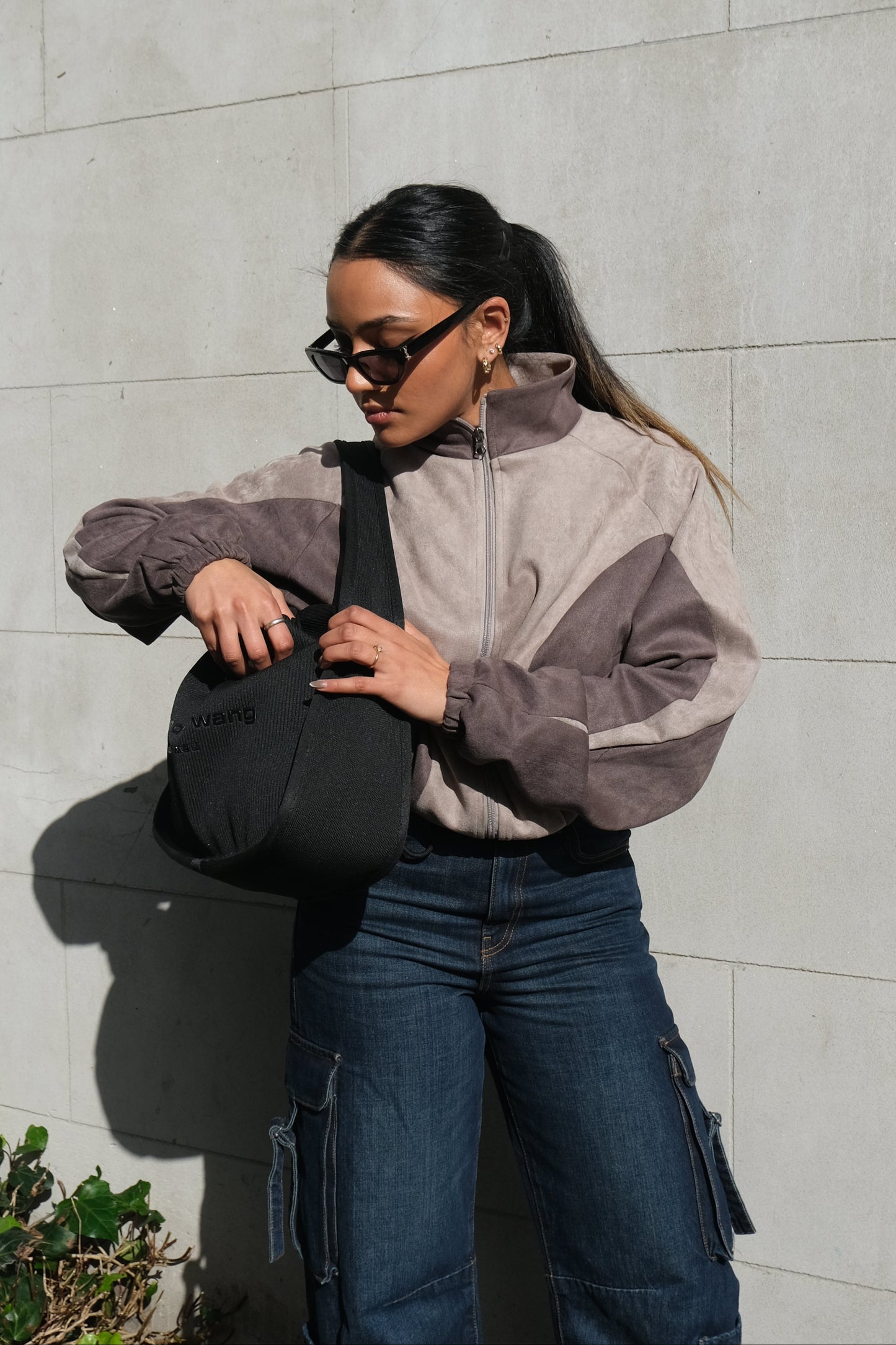 Women's cropped grey jacket featuring front zip closure and functional side pockets – soft fabric with a relaxed casual fit.