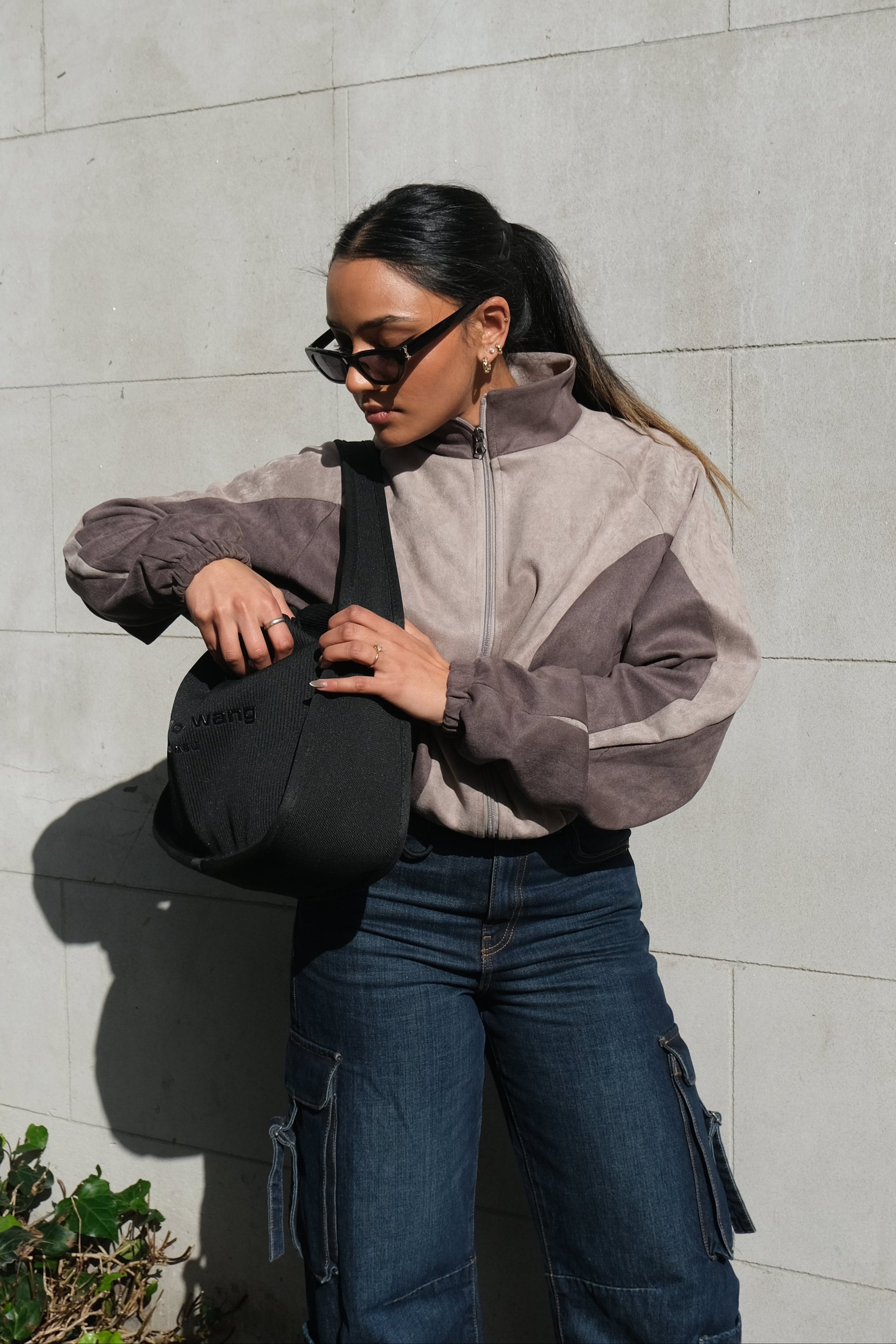 Women's cropped grey jacket featuring front zip closure and functional side pockets – soft fabric with a relaxed casual fit.
