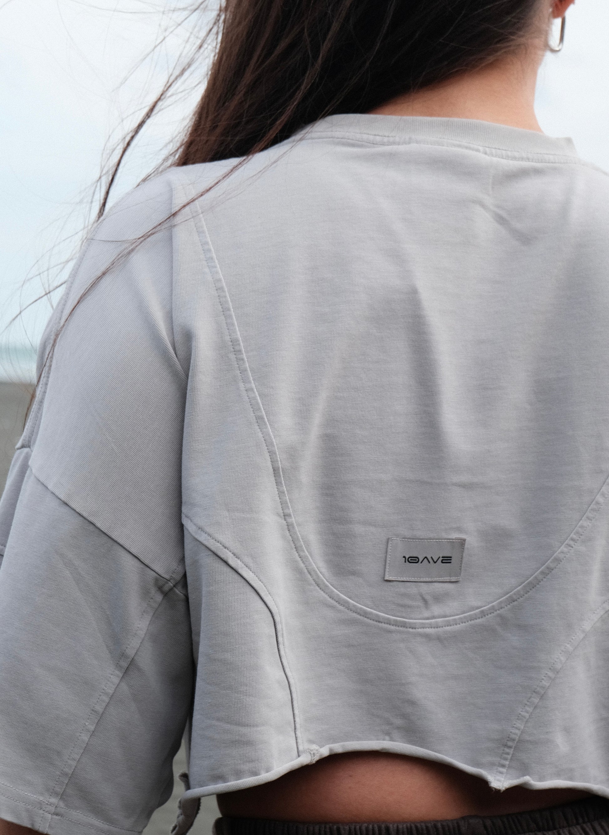 Gray t-shirt with a brand logo on the back