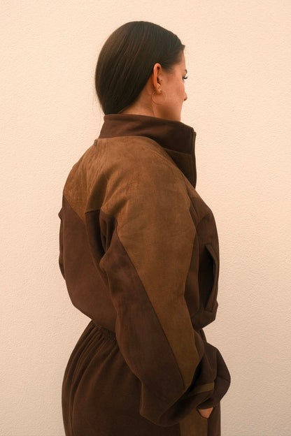 Cropped mocha brown women’s streetwear jacket with front zipper, side pockets, and unique geometric cutouts on the back – relaxed fit and soft brushed fabric.
